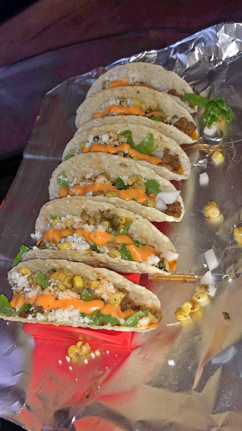 Street tacos with charred corn, queso fresco, and chile crema