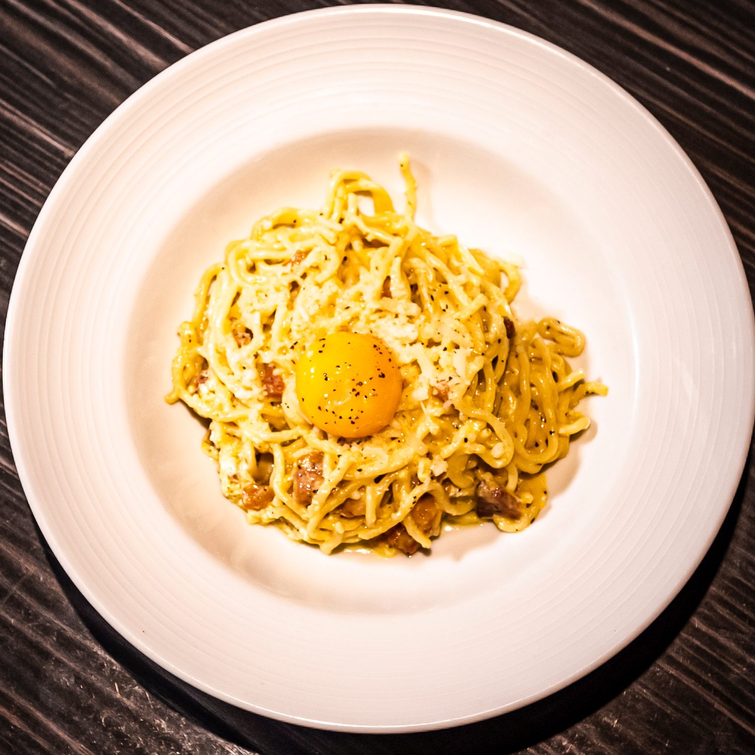 Hand-cut carbonara with cured egg yolk