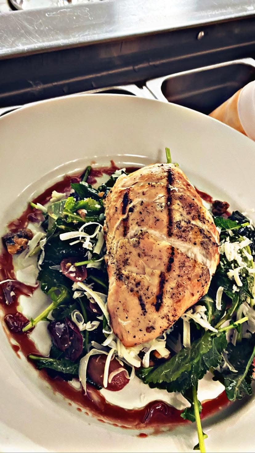 Grilled chicken over kale, grapes, and pecorino