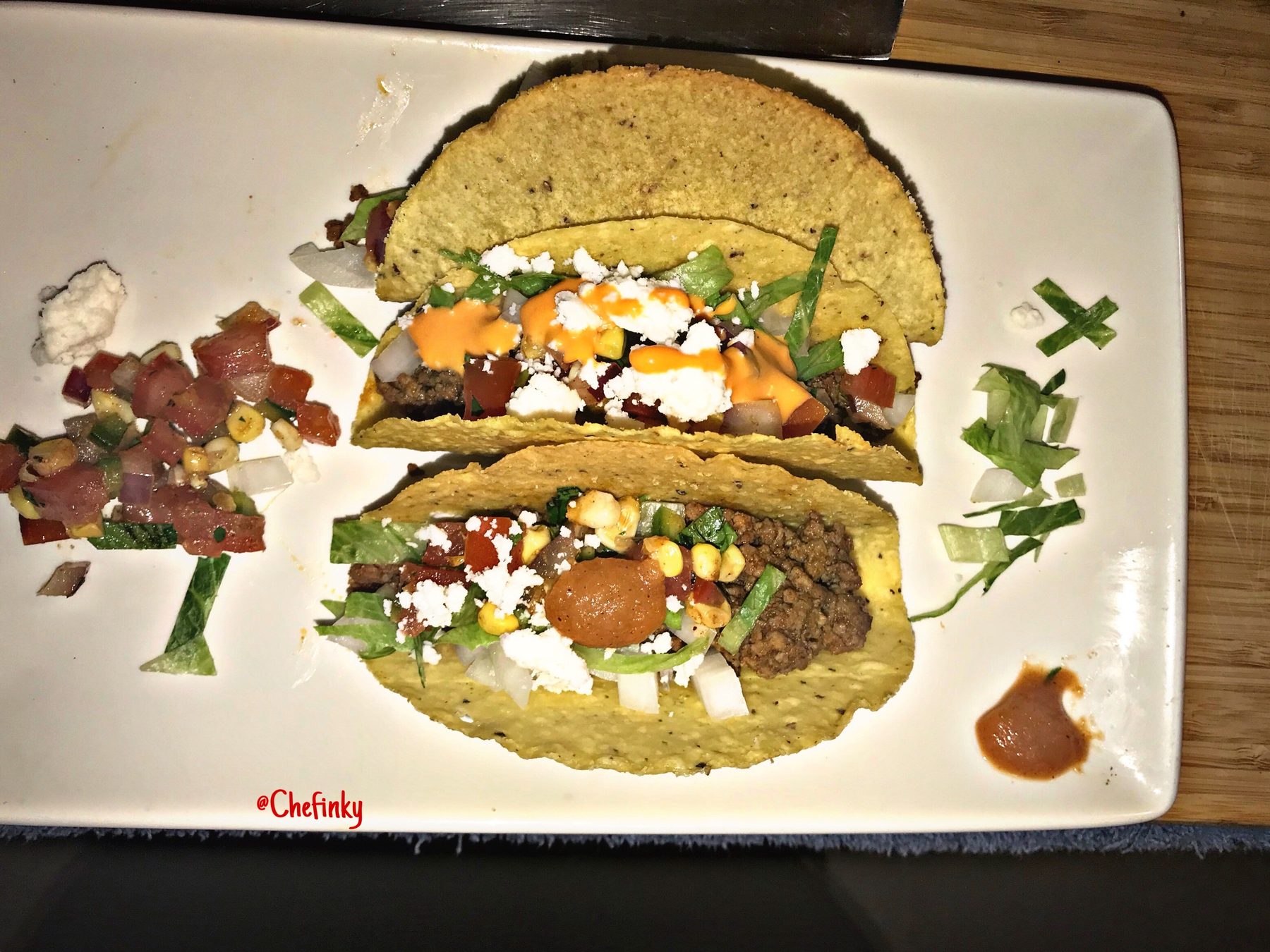Plated tacos with charred corn salsa and queso fresco