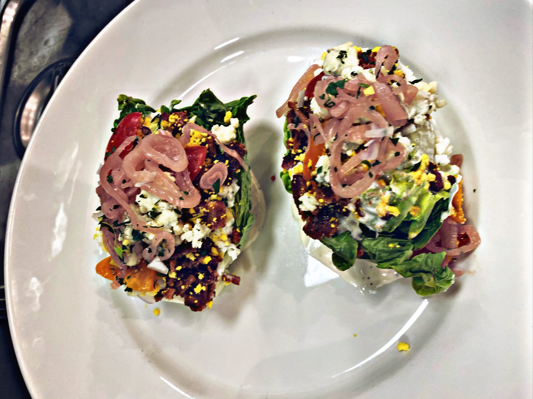 Baby wedge salads with bacon, pickled shallot, and cured egg yolk